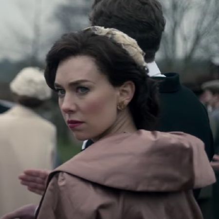 Vanessa Kirby is looking behind her with a serious look.